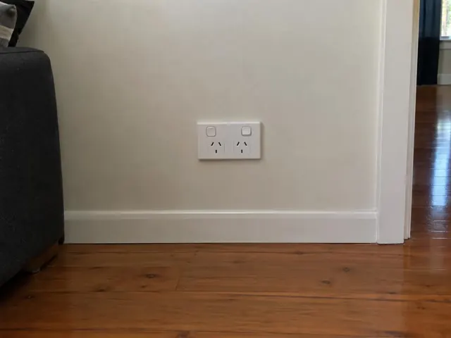 Double power point on a painted interior wall above timber skirting in a home in Fern Bay
